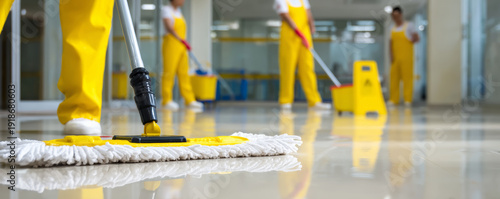 Cleaning service janitor mop floor uniform teamwork office hygiene safety sign corridor professional cleaning crew working cheerfully shiny office