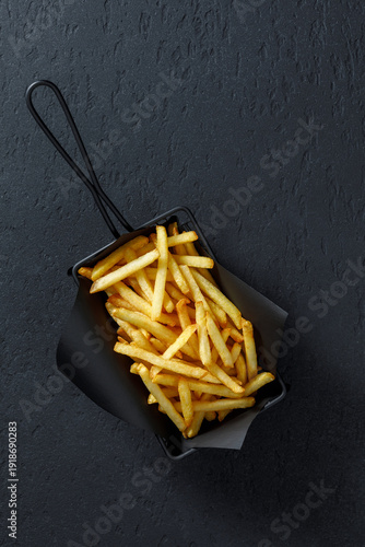 French fries in black serving basket