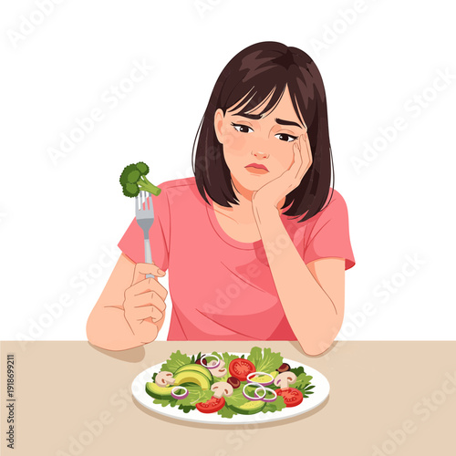 A young woman looking bored and unhappy while holding a fork with broccoli over a plate of healthy salad, indicating a dislike for healthy eating.