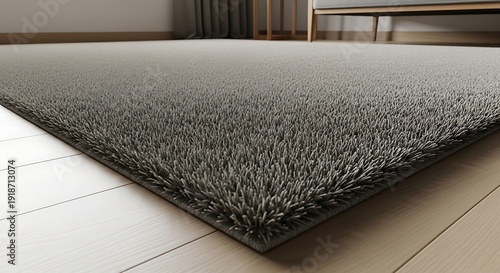 Modern grey shaggy rug close up on light oak wooden floor in minimalist living room interior with soft shadows and blurred furniture background home decoration