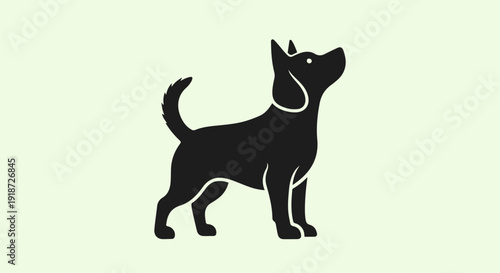 Black dog silhouette standing on light green background looking up simple graphic illustration