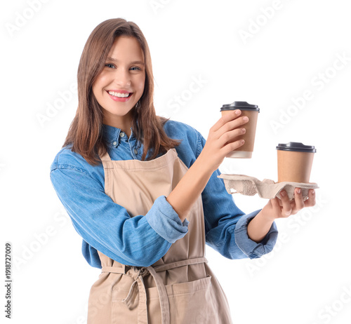 Happy young female barista with paper cups of coffee on white background