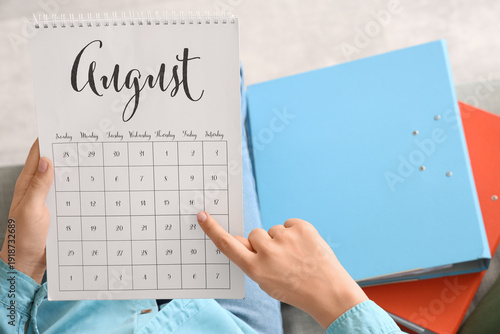 Woman with calendar and fol...