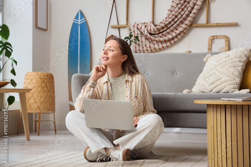 Young woman using laptop wi...