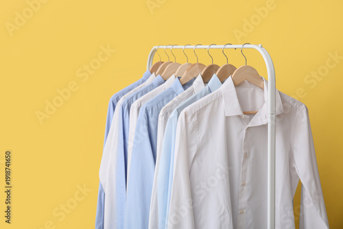 Wallpaper Mural Rack with stylish collar shirts on yellow background Torontodigital.ca