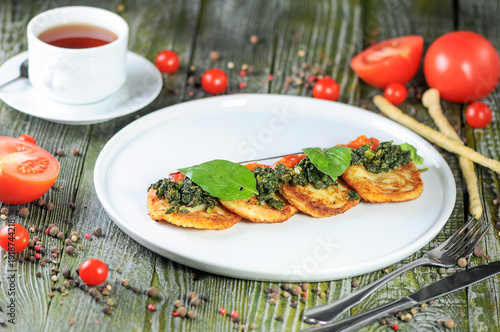 Savory Pancakes with Pesto and Tomato Sauce on a Rustic Table
