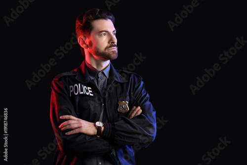 Male police officer with ba...