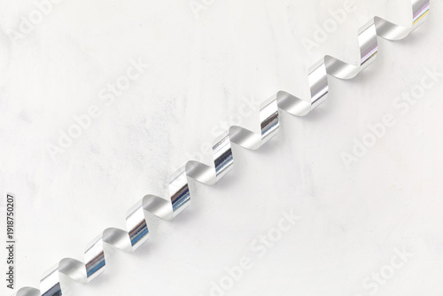 Silver serpentine on white ...