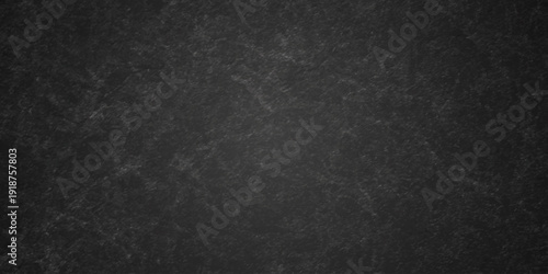 Dark charcoal grunge wall texture background. Dark black rough grunge surface with smoke edge. Black texture chalk board and black board.