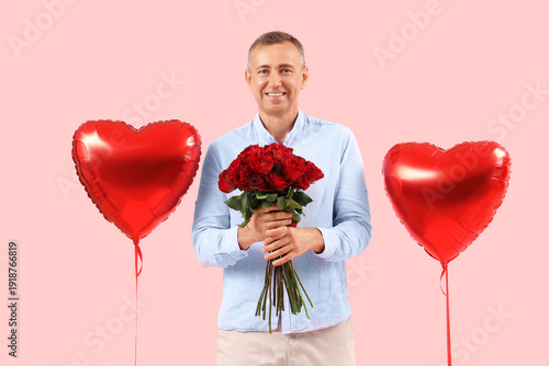 Happy mature man with bouqu...