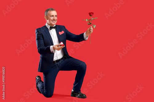 Happy mature man with rose ...