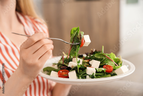 Young woman holding plate o...