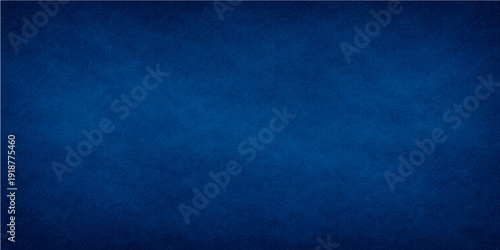 A dark blue grunge paper texture with a vintage denim fabric pattern and rough textile surface design for a weathered material backdrop