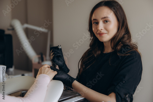 Canvas Print Woman manicurist providing professional nail care service