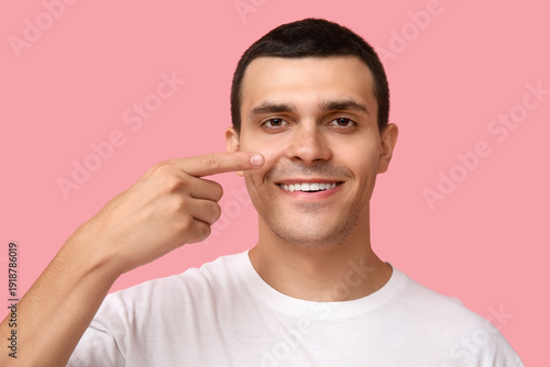 Ill young man pointing at n...