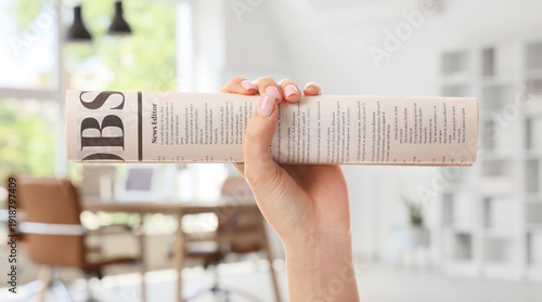 Female hand and newspaper o...