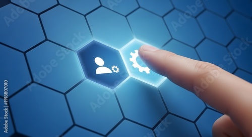 Finger touching a glowing gear on a blue hexagonal grid
