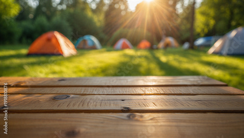 Empty Wooden Table Top Mockup with Blurred Campsite Tents and Golden Sunlight Background