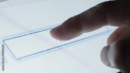Human finger tapping an empty input field on a bright digital screen with a moving cursor for user interaction concept and online data entry