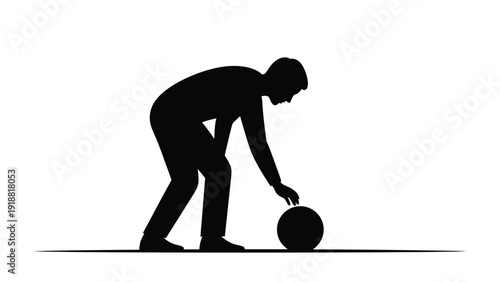 Silhouette of a businessman or athlete in a forward bending posture preparing to roll a dark sphere on a flat surface