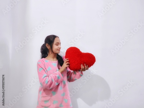 asian girl posing with a laptop, with a heart plushy for Valentine's Day, with a smartphone doing poses like happy, smile, angry and excited, acting as Gen Z and working lady and working from home