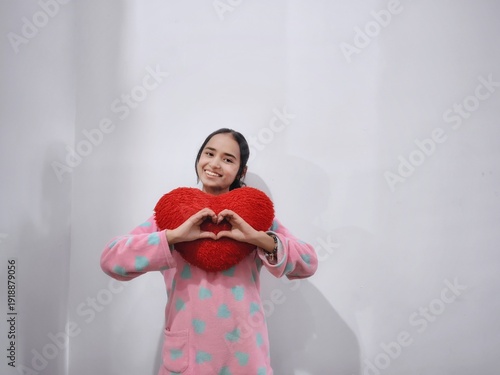 asian girl posing with a laptop, with a heart plushy for Valentine's Day, with a smartphone doing poses like happy, smile, angry and excited, acting as Gen Z and working lady and working from home