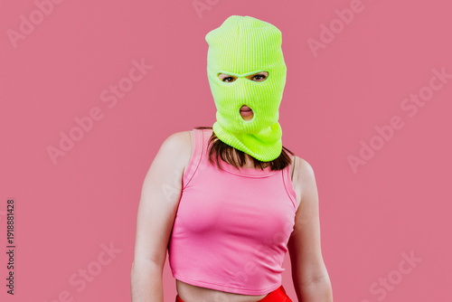 Tableau sur toile Woman wearing neon balaclava making a hand gesture