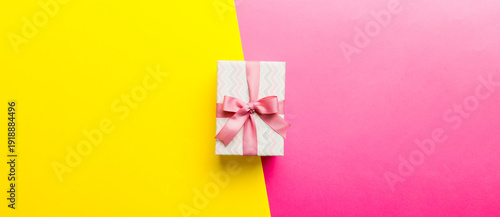 Wallpaper Mural holiday paper present tied pink ribbon bow top view with copy space. Flat lay holiday background. Birthday or christmas present. Christmas gift box concept with copy space Torontodigital.ca