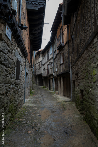 Narrow cobblestone street with stone buildings.. La Alberca, in the province of Salamanca, Spain