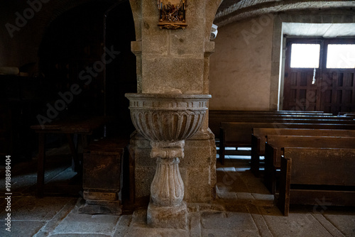 Billede på lærred Interior of a church with wooden benches and baptismal font