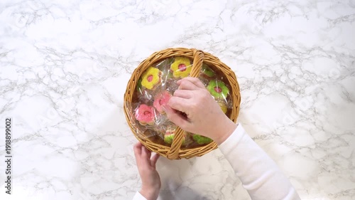 Adjusting Gift Basket with Wrapped Cookies