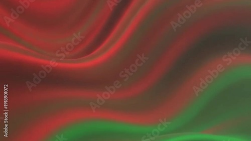 Flowing red and green satin fabric creating a smooth pattern