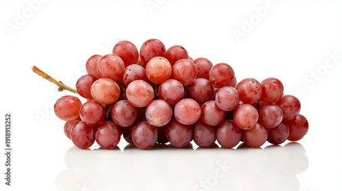 A lush cluster of red seedless grapes is artfully arranged against a white background