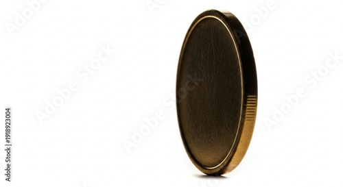A gold coin standing upright on its edge, isolated on a plain background, viewed from the side