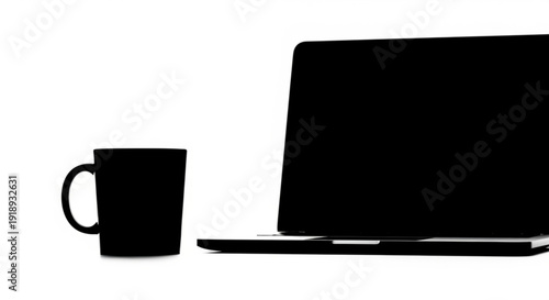 Modern workspace setup featuring a laptop and a coffee mug on a clean desk viewed from the side