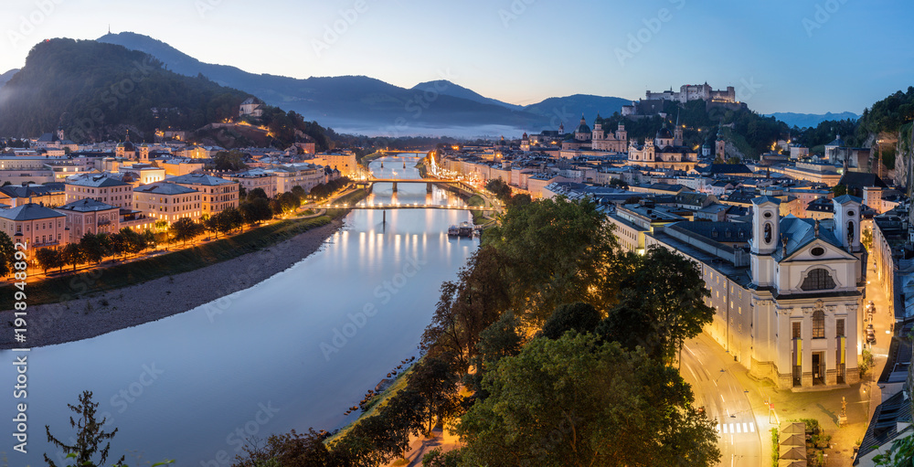 Fototapeta premium Salzburg - The panorama of old town at evening dusk with the Salzach river.