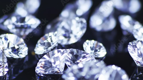Close-up view of many faceted diamonds on a dark surface, showcasing their brilliance and intricate cuts