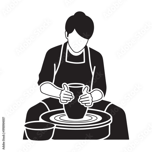 Potter creating ceramic vessel on spinning wheel in studio