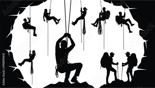 Silhouettes of climbers ascending ropes inside a rocky cavern