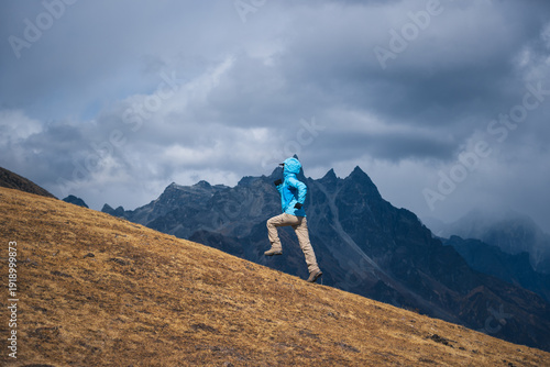 Woman trail runner running on mountain top