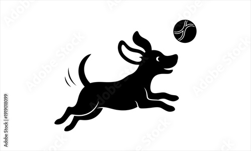 Silhouette of a black dog joyfully jumping to catch a ball in the air
