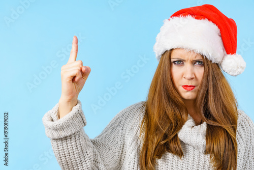 Woman threatens with finger, serious face expression