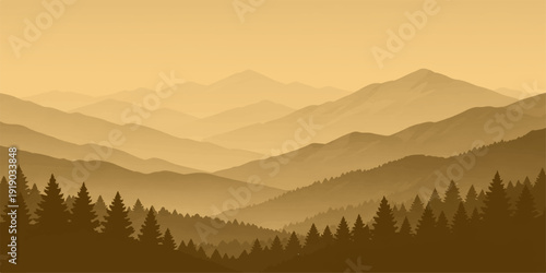 A beautiful morning view of a misty mountain landscape at sunrise where fog settles over the forest valley and snow-capped peaks under a blue sky at dawn