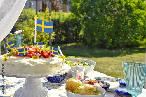 Photos A cake decorated with strawberries, new potatoes and herring to celebrate the summer solstice on the festive table
