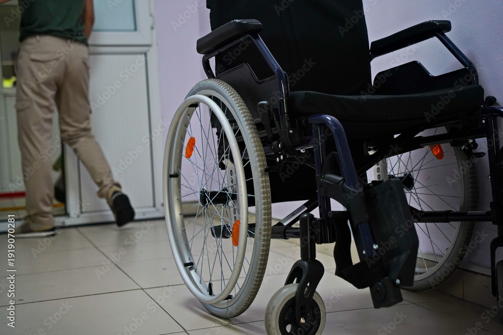 Fototapeta premium Wheelchair in the corner, at the entrance to the city hospital.