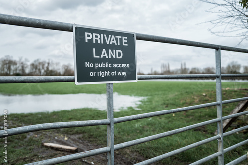 Photos Close up of a newly installed Private Land metal sign at the gated entrance to farm pasture and a rural conservation area in the UK