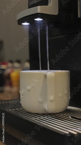 Hot water pouring into coffee mug for Americano on office desk during work break
