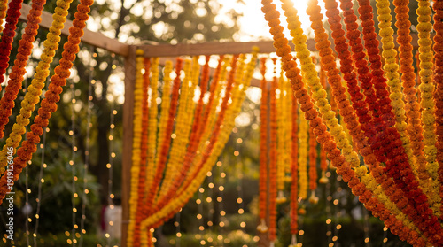 Marigold flower garland hanging on green blur background. Banner template for autumn festival or toran Indian traditional Diwali, Day of dead, wedding, copyspace