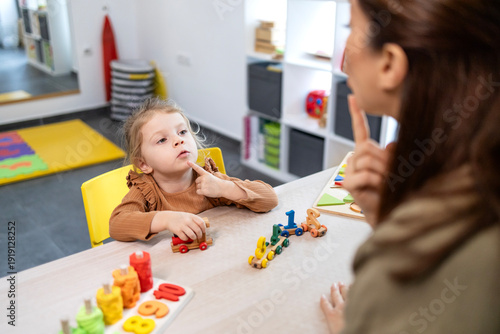 Child learning speech therapy with a professional therapist, focusing on language development, communication disorders, and early childhood education in a specialized clinic