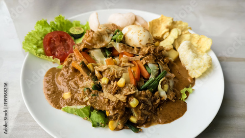 Wallpaper Mural A vibrant and nutritious Indonesian-inspired mixed vegetable salad with rich peanut dressing, hard-boiled eggs, and crispy crackers, offering a complete and flavorful healthy meal Torontodigital.ca